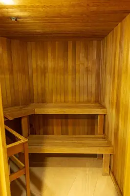 a small sauna with wooden shelves and a stool at 1BR next to slopes on Blackcomb w pool & hot tub in Whistler