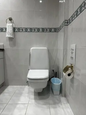 a bathroom with a toilet and a toilet paper dispenser at Luxury Vancouver Suite Near YVR and Downtown in Vancouver