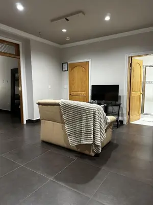 a living room with a couch with a blanket on it at Luxury Vancouver Suite Near YVR and Downtown in Vancouver