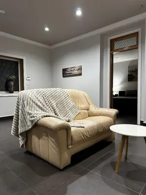 a living room with a couch with a blanket on it at Luxury Vancouver Suite Near YVR and Downtown in Vancouver