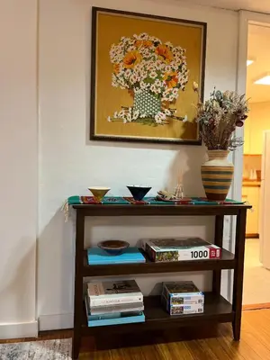 a shelf with a painting of a flower vase at Peter's Place - Spacious 2Bed & Bath Suite in Surrey