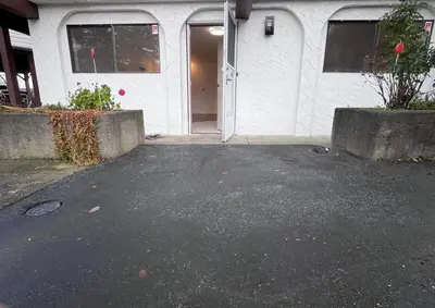 an empty parking lot in front of a building at Peter's Place - Spacious 2Bed & Bath Suite in Surrey
