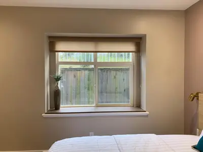 a bedroom with a window with a vase on it at The Scandinavian House by Maple Dream Homestay- near Sky train in Vancouver