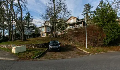 a car parked in front of a house at 2 BR Spacious Ground Level Suite in Victoria