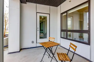 a table and two chairs on the porch of a house at Pet Friendly, Free Parking, Close to Downtown in Calgary