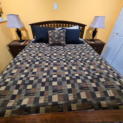 a bedroom with a bed with two lamps on tables at Ocean's Edge in Port Alice