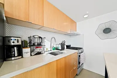 a kitchen with a sink and a stove at The Urban Lofts in Vancouver