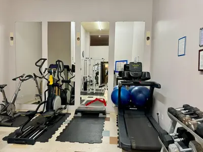 a gym with several treadmills and exercise machines at The Urban Lofts in Vancouver