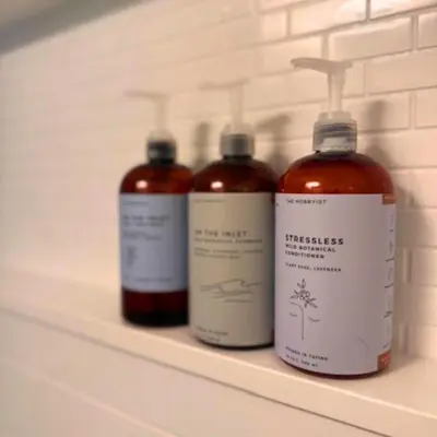 three bottles of medicine sitting on a shelf at High Tide - Waterfront bachelor in Tofino