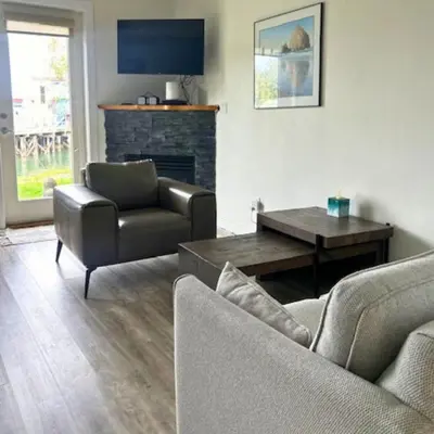 a living room with a couch and a table at High Tide - Waterfront bachelor in Tofino