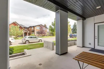 a patio with a bench and a view of a street at Free Heated Parking, Quick DT Access in Calgary