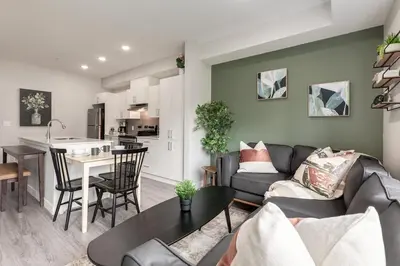 a living room with a couch and a table at Free Heated Parking, Quick DT Access in Calgary
