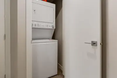 a kitchen with a refrigerator and a microwave at Free Heated Parking, Close to DT, Pet Friendly in Calgary