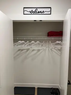 a closet with a white shelf with a welcome sign on it at Luxurious, Centrally Located Home in Cavanagh in Edmonton