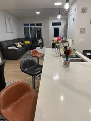a kitchen and living room with a white counter top at Luxurious, Centrally Located Home in Cavanagh in Edmonton