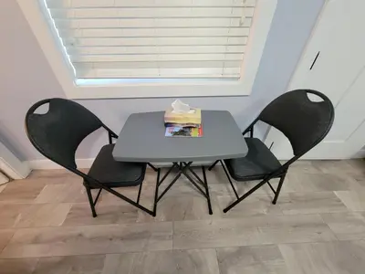 a white table with two chairs and a box on it at Gladiola Bed & Breakfast in Victoria
