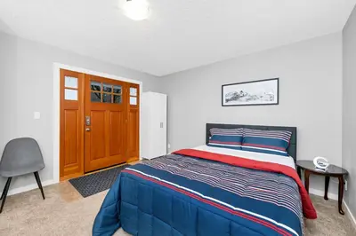 a bedroom with a blue bed and a wooden door at Home away from Home in Victoria