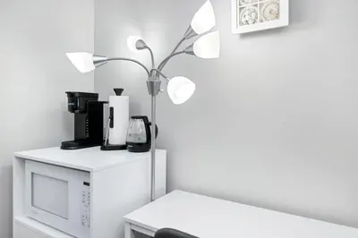 a room with a microwave and a lamp on a table at Home away from Home in Victoria