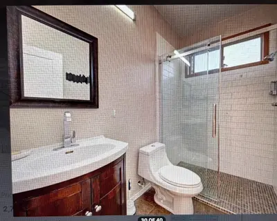 a bathroom with a toilet and a sink and a shower at Beaches Downtown Suite In Sechelt in Sechelt