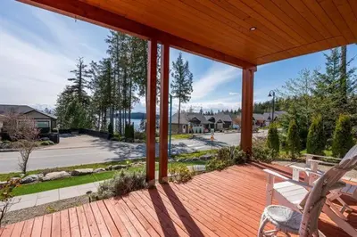 a porch with a bench and a view of a street at Beaches Downtown Suite In Sechelt in Sechelt