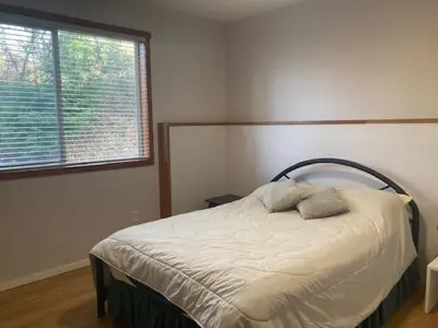 a bedroom with a bed with two pillows on it at Beaches Downtown Suite In Sechelt in Sechelt