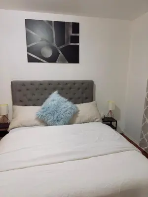 a bed with a blue stuffed animal on top of it at Covepark house in Calgary
