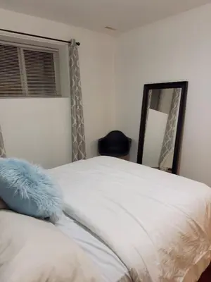 a bedroom with a bed and a mirror at Covepark house in Calgary