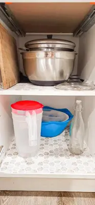a shelf with some dishes and a bowl and a pot at Casa Andrei in Edmonton