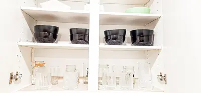 a shelf filled with glass vases and bowls at Casa Andrei in Edmonton