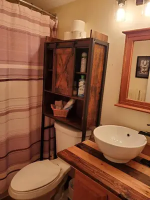 a bathroom with a white toilet and a sink at Cozy Quiet Suite with Private Hot Tub with Ocean Views in Nanaimo