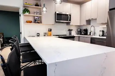 a white kitchen with a large white counter top at Lucid Lemming in Revelstoke