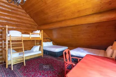 a room with two bunk beds in a cabin at Ravenwood Cabin by StayIn in Panorama