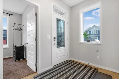 an empty hallway with a door and a window at Private Master Bed Room SPRING in Edmonton