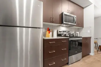 a kitchen with a stainless steel refrigerator and a microwave at Private Master Bed Room SPRING in Edmonton