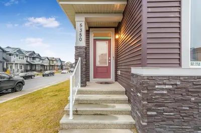 a house with a red door on a street at Private Master Bed Room SPRING in Edmonton