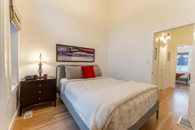 a bedroom with a bed and a dresser and a window at Alpine Village Condo by Canadian Rockies Vacation Rentals in Canmore