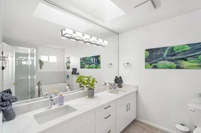 a bathroom with two sinks and a large mirror at Spacious Family Retreat Central to YVR and Downtown in Vancouver