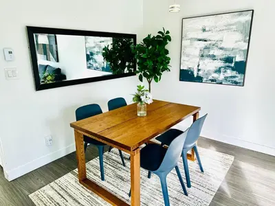 a dining room with a wooden table and blue chairs at Beautiful condo beach side Yaletown in Vancouver