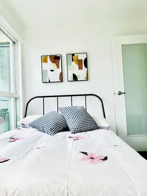 a bedroom with a bed with pink flowers on it at Beautiful condo beach side Yaletown in Vancouver