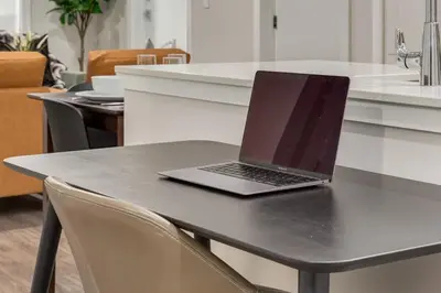 a laptop computer sitting on top of a table at Free Parking, Pet Friendly, Close to DT in Calgary