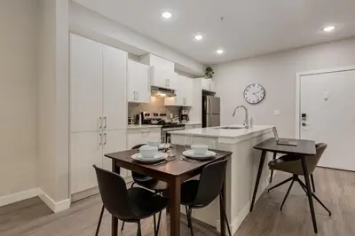 a kitchen and dining room with a table and chairs at Free Parking, Pet Friendly, Close to DT in Calgary
