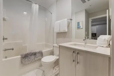 a white bathroom with a toilet and a sink at Free Parking, Pet Friendly, Close to DT in Calgary