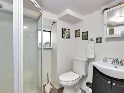 a bathroom with a shower and a toilet and a sink at Private Suite With Spacious Yard in Vancouver