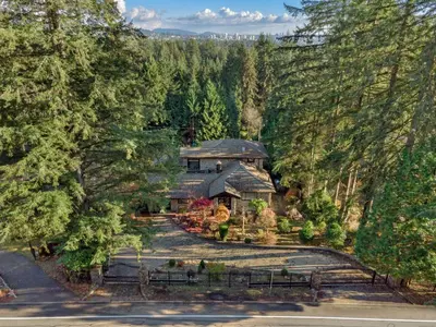an aerial view of a house in the woods at Elegant West Vancouver Estate with Ocean Views in West Vancouver