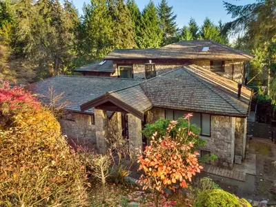 a house with a roof on top of it at Elegant West Vancouver Estate with Ocean Views in West Vancouver