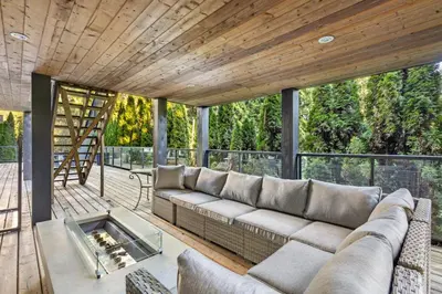 a living room with a couch and a table at Elegant West Vancouver Estate with Ocean Views in West Vancouver