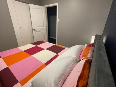 a bedroom with a bed with a colorful blanket at Welcome to Shibly's Retreat in Edmonton