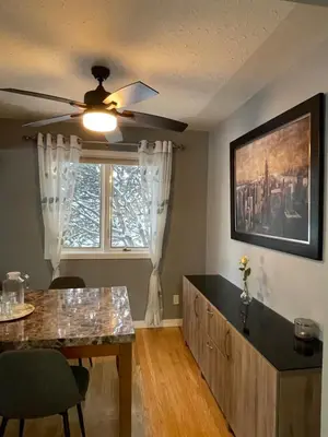 a dining room with a ceiling fan and a window at Welcome to Shibly's Retreat in Edmonton