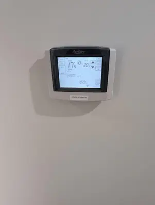 a computer monitor is on a white wall at DaraJay Cozy Home in Calgary