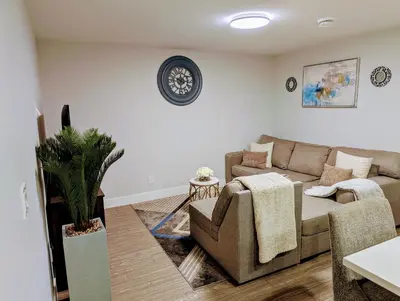 a living room with a couch and a table at DaraJay Cozy Home in Calgary